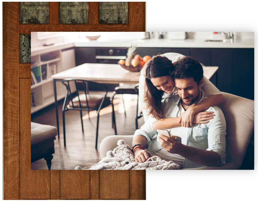 Couple-in-the-living-looking-at-their-cell-phone